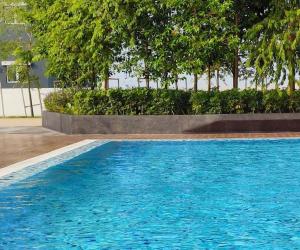 a large blue swimming pool with trees in the background at D2303 Camellia Stay, Alanis Near KUL Airport in Sepang +9 photos