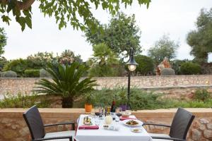 
a table set up for a meal at a restaurant at Hotel Son Trobat Wellness & Spa in Sant Llorenç des Cardassar
