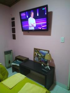 Una sala de estar con un televisor de pantalla plana en la pared. en Lofalu, en Gobernador Gregores