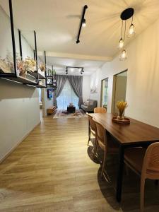ブリンチャンにあるAdamhawa Homestay 3 Emerald Avenue Brinchangのテーブルと椅子のあるダイニングルームとリビングルーム