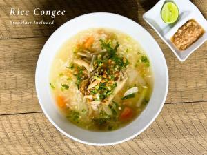a bowl of chicken noodle soup on a table at The Little Vegan Homestay in Phumĭ Bântéay Srei