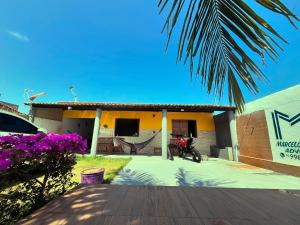 a house with a motorcycle parked in front of it at Dr House veraneio Abaís praia SERGIPE in Praia Da Caueira