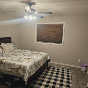 a bedroom with a bed and a ceiling fan at Completely Modern Furnished Private House Near Mayo Clinic in Rochester
