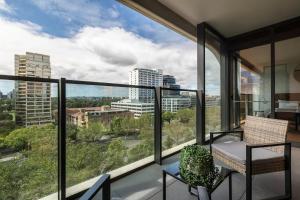 a balcony with a view of a city at Lavish Condo Prestigious St Kilda Rd Boulevard in Melbourne