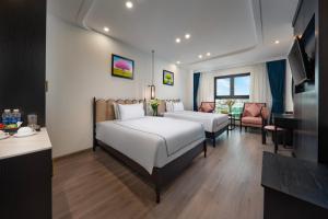Postel nebo postele na pokoji v ubytování SQ Hang Gai hotel & Spa