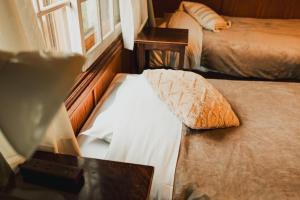Postel nebo postele na pokoji v ubytování Hakuba Pension & Log Hotel Meteor