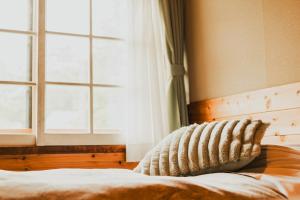 Postel nebo postele na pokoji v ubytování Hakuba Pension & Log Hotel Meteor