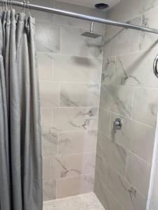 a shower with a shower curtain in a bathroom at CasaNinos, casa de la gente buena in Aguascalientes +56 photos