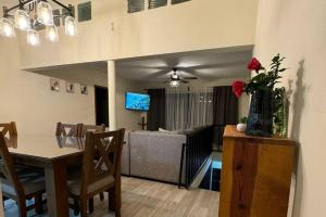 a dining room and living room with a table and a couch at CasaNinos, casa de la gente buena in Aguascalientes