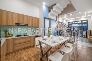 a kitchen and dining room with a table and chairs at NNP Apartment Beach. in Da Nang
