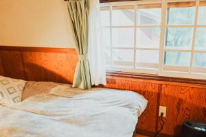 Postel nebo postele na pokoji v ubytování Hakuba Pension & Log Hotel Meteor
