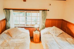 Postel nebo postele na pokoji v ubytování Hakuba Pension & Log Hotel Meteor