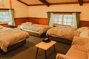 Postel nebo postele na pokoji v ubytování Hakuba Pension & Log Hotel Meteor