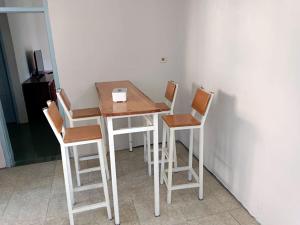 a table with four chairs and a table with a box on it at OIKOS GREEN - Homestay in Kuningan +19 photos