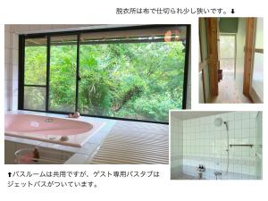 a bathroom with a pink tub and a large window at リラシャンティRelashanti in Soni