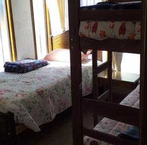 a bedroom with two bunk beds and a bed at Cabañas de Los Trigales in Guanaqueros +2 photos