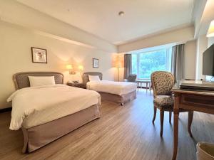 Postelja oz. postelje v sobi nastanitve Le Midi Hotel Chitou