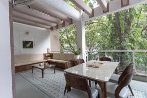a dining room with a table and chairs at Bauhinia in Pune