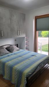 a bedroom with a large bed and a window at CASA VACANZE RELAX in Riva di Solto