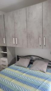 a bedroom with a bed with gray cabinets at CASA VACANZE RELAX in Riva di Solto +32 photos