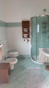 a bathroom with two toilets and a glass shower at CASA VACANZE RELAX in Riva di Solto