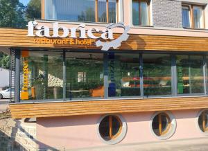 a restaurant with a sign on the side of a building at Hotel Fabrica in Liberec
