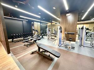 a gym with several treadmills and machines at High Rise Condo with Balcony, Pool, Grand Lobby,Gym and Sky Garden 22F in Manila
