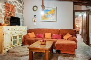 a living room with a couch and a table at La Fragua in Villar de Corneja