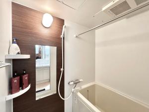 a bathroom with a bath tub and a sink at Shinjuku-STS Hostel in Tokyo +53 photos