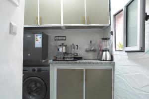 a kitchen with a washing machine and a washer at Tangier city center 3 in Tangier