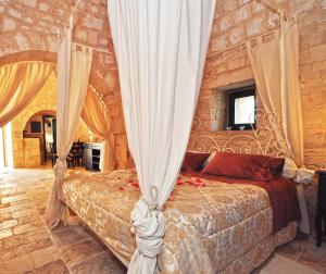 Llit o llits en una habitació de Masseria Rosa Trulli Relais