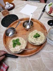 a wooden tray with two plates of food on a table at chez Germaine in Lourdes +17 photos