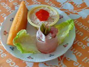 a plate of food with vegetables and a carrot at chez Germaine in Lourdes