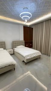 Postel nebo postele na pokoji v ubytování Al Reef Apartment