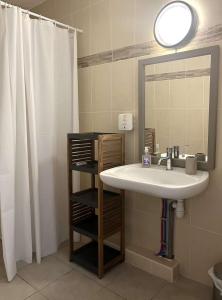 a bathroom with a sink and a mirror at SAINT-FLORENT Studio PISCINE FLO300-146 in Saint-Florent +9 photos