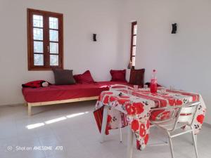 a living room with a table and a couch at Maison La rose 1 in Mezraya