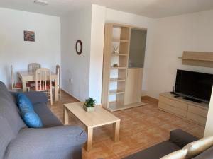 a living room with a couch and a table at Brisas del mar in Puerto de Mazarrón
