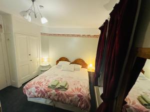 a bedroom with a bed with two shoes on it at The Bliss 9 Home Stay, En-suite, Self check in with smart lock, Non Smoking Home in and out, Zero tolerance for noise after 11pm in Southampton