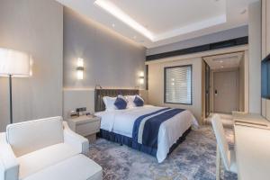 Voodi või voodid majutusasutuse Chongqing Liyuan Hotel toas