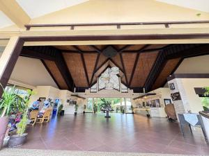 a lobby of a building with people sitting in chairs at Alta Vista De Boracay, Loft 304 in Boracay
