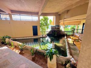 a room with a pond in the middle of a house at Alta Vista De Boracay, Loft 304 in Boracay