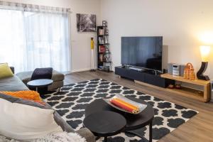 a living room with a couch and a tv at Wotama, Macedon B and B, Honour Ave, Mount Macedon in Mount Macedon