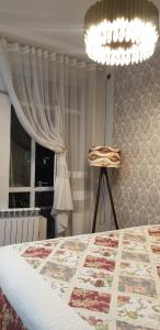 a bedroom with a bed and a chandelier at Dushanbe City in Dushanbe +3 photos