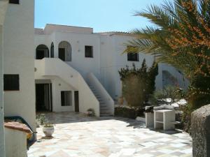 a white building with a staircase in front of it at La Parata Apartments in Mojácar