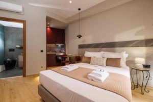 Postel nebo postele na pokoji v ubytování Jolly Suites