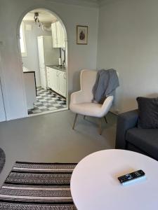 un soggiorno con un divano, una sedia e un tavolo di Lite hus med egen inngang - Sentral beliggenhet a Haugesund
