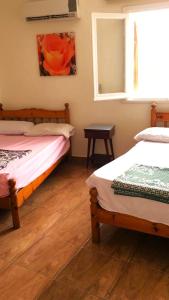 a room with two beds and a window at Maamoura Beach apartment in Alexandria +24 photos