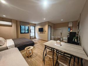 a room with a bed and a table in it at 57 Hidden House BKK Chinatown in Bangkok