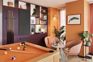 a living room with a pool table and a chair at Stay KooooK Geneva City - Online Check In in Geneva +17 photos