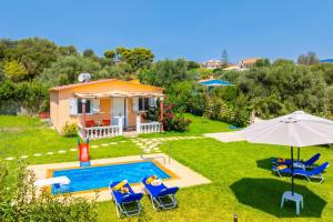 a villa with a swimming pool and a house at Villa Eleftheria in Spartià